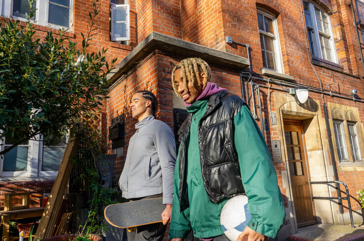 Two young people connecting about anti-black racism as they walk side by side